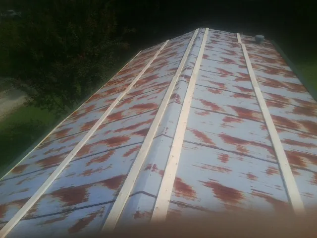 Rusted metal roof panels with new wood purlins before replacement — Storm Damage Roof Repair in Rufus by Roofing Brothers